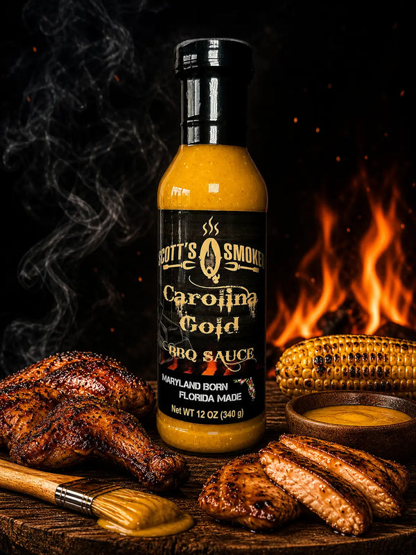 Carolina Gold BBQ sauce 12oz bottle with grilled chicken, corn, and wooden brush against fiery background