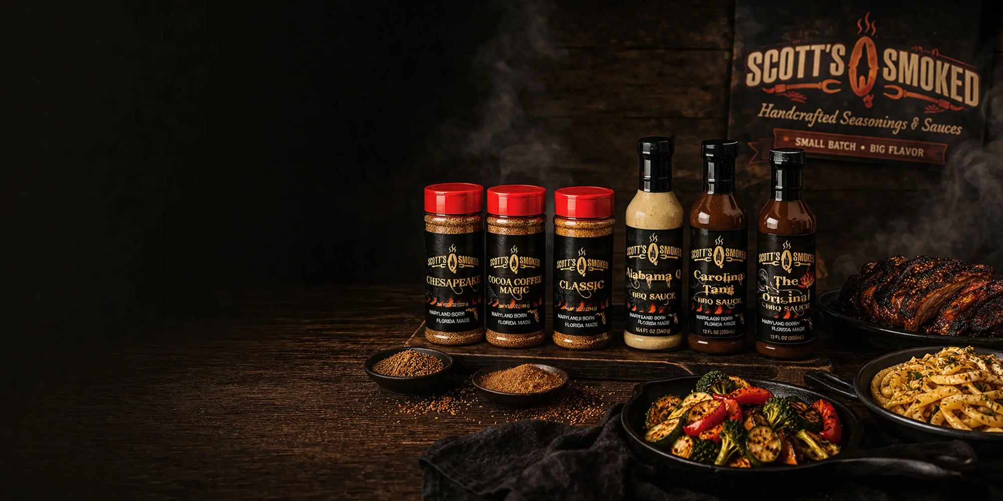 Assorted Scott's Smoked seasonings and sauces displayed with grilled ribs and pasta dishes on a dark wooden table.