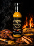 Barbecue sauce bottle with grilled chicken, corn, dipping sauce, and flames in background.