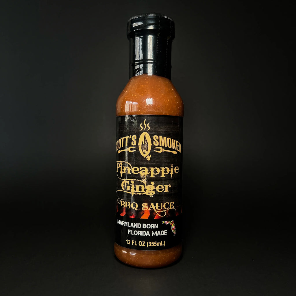 Bottle of Scott's Smoked Pineapple Ginger BBQ Sauce against a dark background.