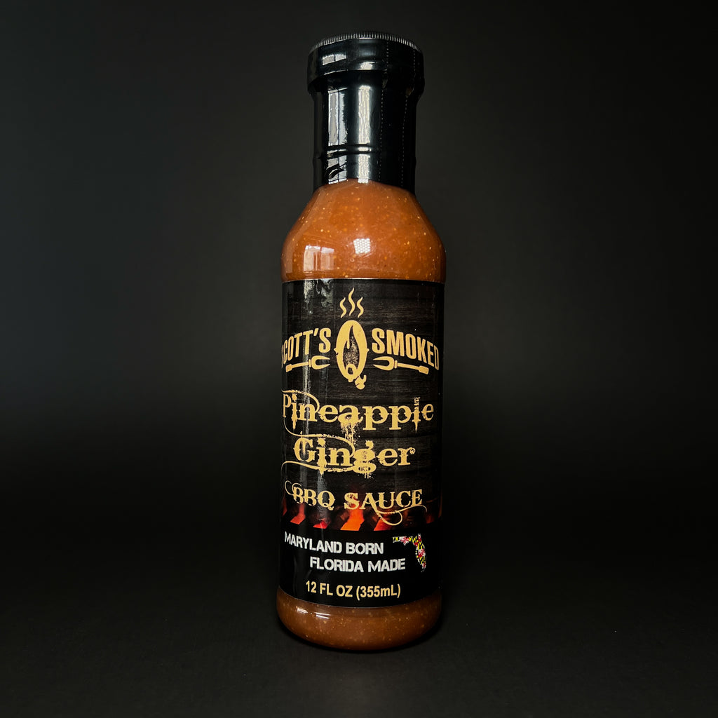 A bottle of Pineapple Ginger BBQ sauce on a dark background.