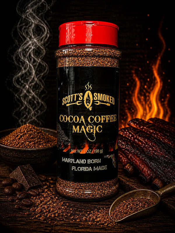 Jar of Scott's Smoked Cocoa Coffee Magic with a red lid, surrounded by coffee beans, chocolate, spices, and smoked ribs with flames.