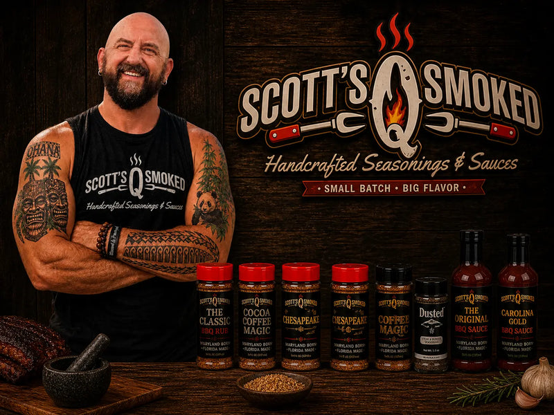 Scott with tattoos wearing a Scott's Q Smoked tank top, standing behind an array of seasonings and BBQ sauces.