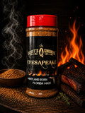 Scott's Smoked Chesapeake seasoning jar with red lid, spices in a bowl, and smoked meat by a fire backdrop.